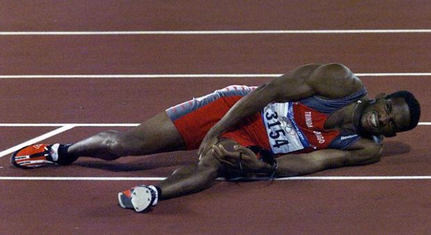 TRINIDAD'S BOLDON HOLDS HIS LEG AFTER THE 200M FINAL IN SYDNEY